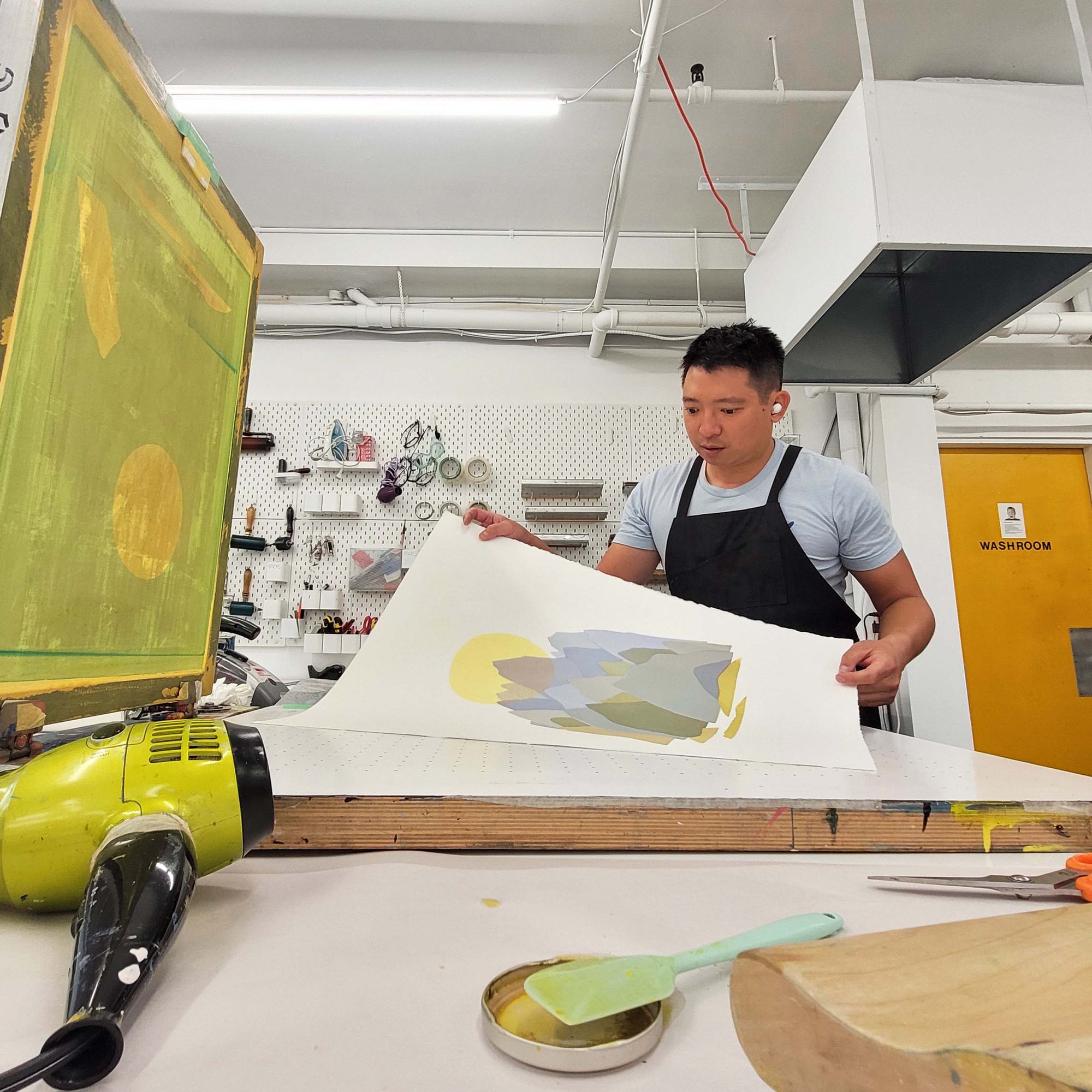 Edward Fu-Chen Juan working in the studio, creating a print