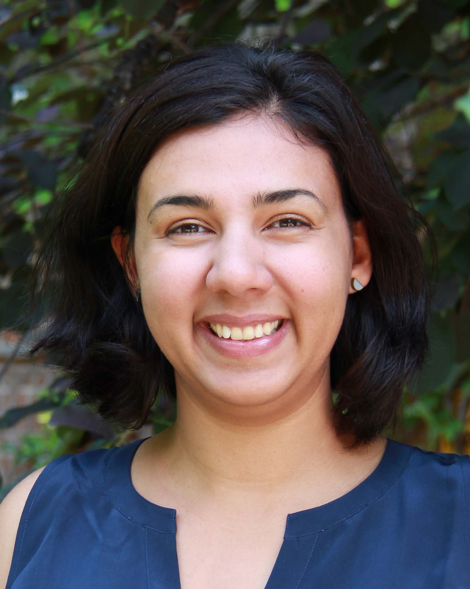 Close-up of Sheila Colla smiling, wearing a blue shirt