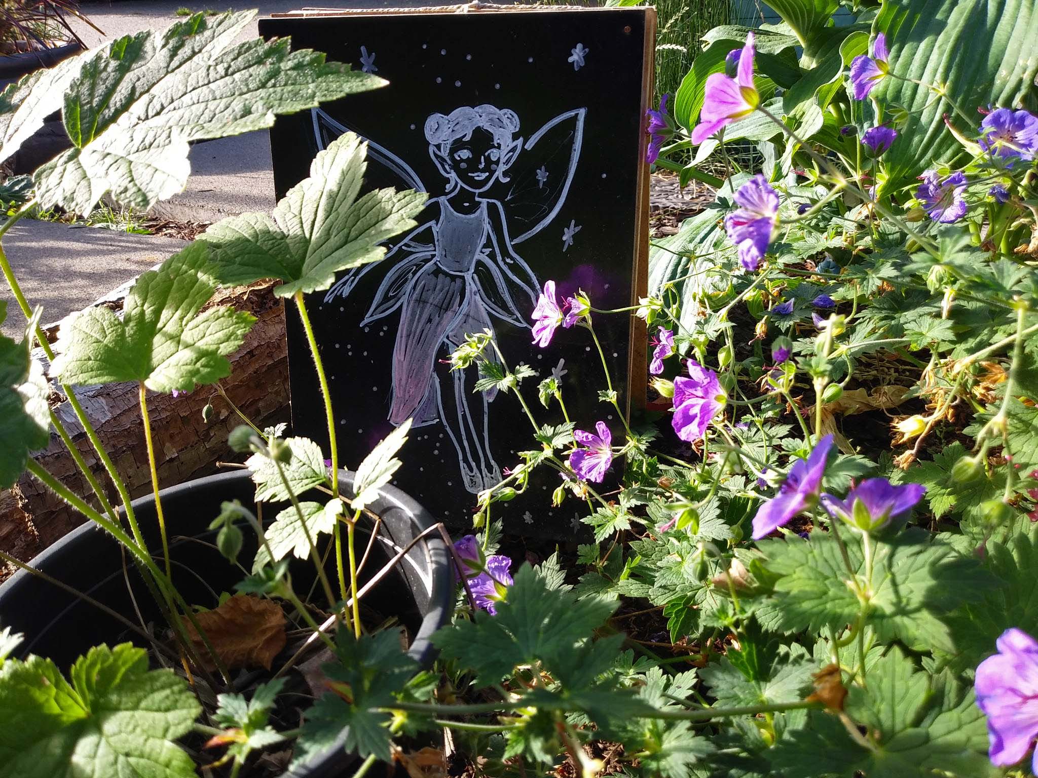 an illustration of a fairy resting among purple-flowering plants